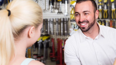 A Honda Specialist smiles as they talk to a customer.  