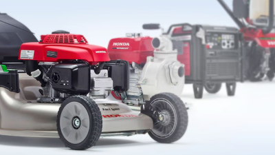 A Honda mower sits in the foreground with other Honda Power Equipment pictured in the background.  